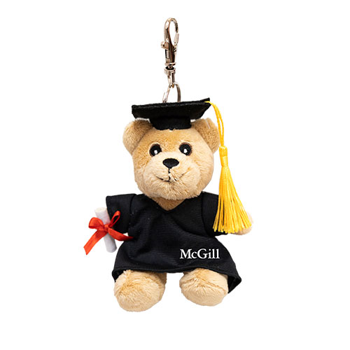 3" plush Grad Bear carrying a detachable diploma and dressed in a cap and gown featuring a golden tassel and “McGill” imprinted on the robe.