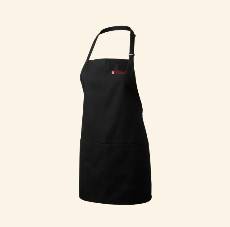 Black adjustable apron with small red McGill logo on the chest