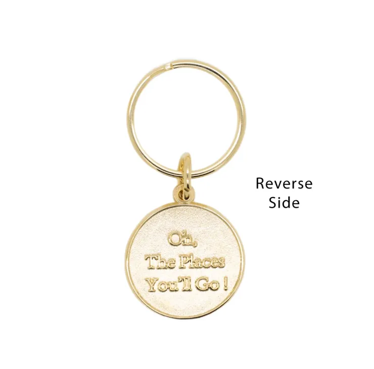 Reverse side of gold Class of 2026 keychain with engraved “Oh, The Places You’ll Go!” message.