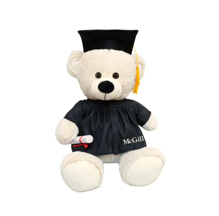 Beige McGill graduation teddy bear wearing black cap and gown with gold tassel, holding rolled diploma.