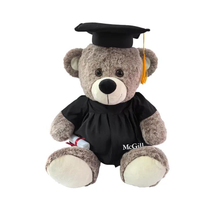 Plush McGill graduation teddy bear wearing black cap and gown and holding a diploma, with McGill logo on robe.