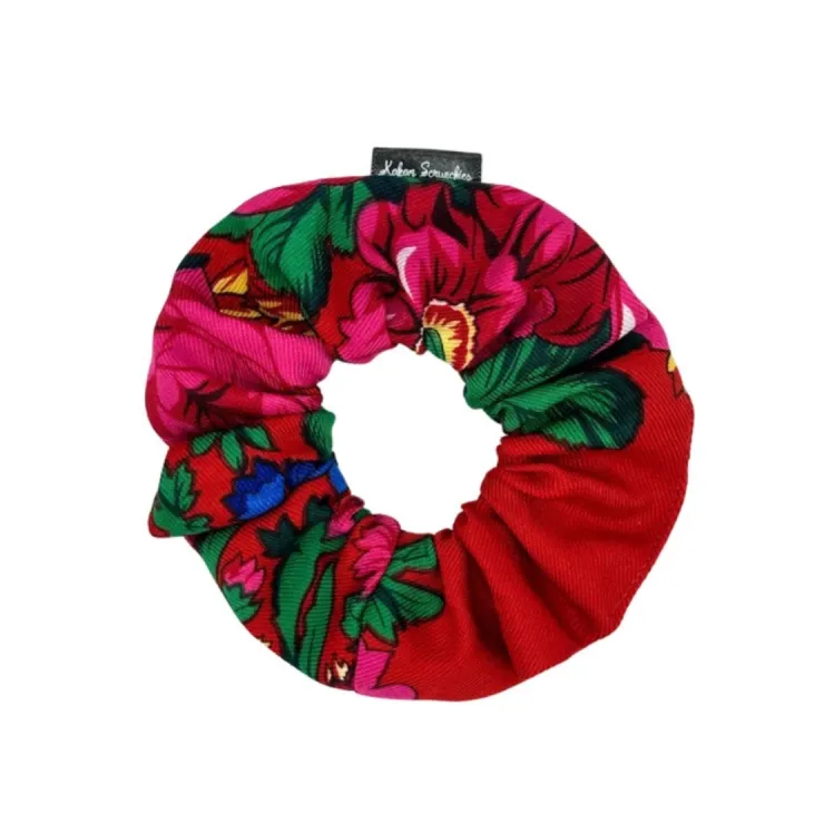 Red floral scrunchie with vibrant pink flowers and green leaves, designed by Kokom Scrunchies.