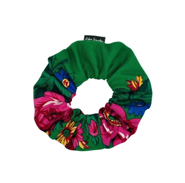 Green floral scrunchie with vibrant pink flowers and green leaves, designed by Kokom Scrunchies.