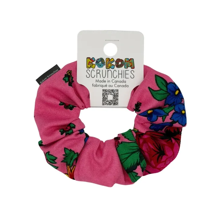 Pink floral scrunchie with vibrant red flowers and green leaves, designed by Kokom Scrunchies.