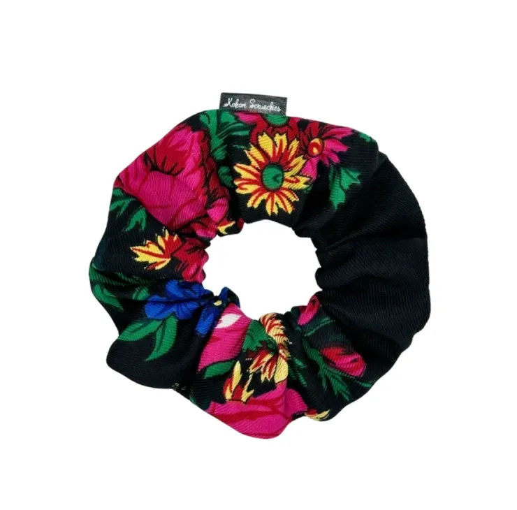 Black  floral scrunchie with vibrant pink and blue flowers and green leaves, designed by Kokom Scrunchies.
