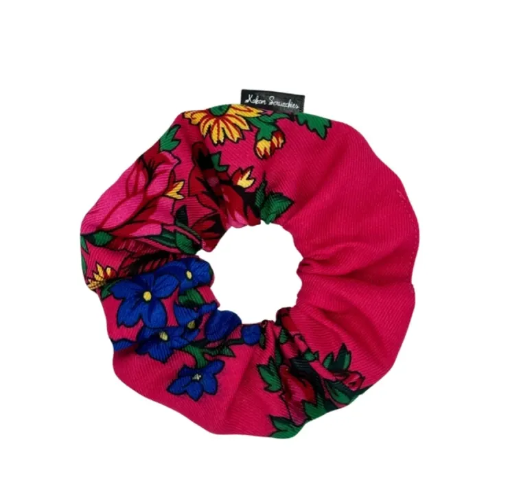 Pink floral scrunchie with vibrant yellow and blue flowers and green leaves, designed by Kokom Scrunchies.
