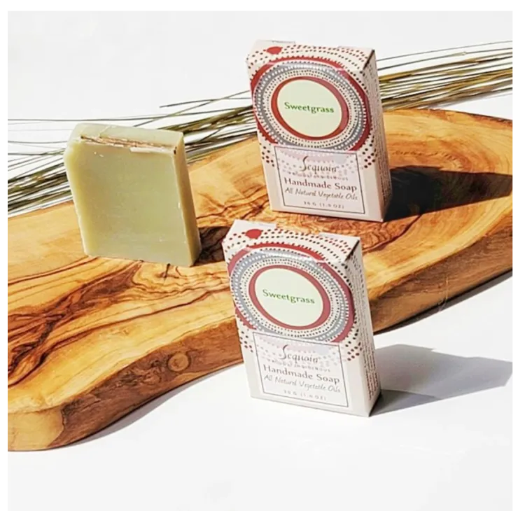 Sequoia Sweetgrass handmade soap bar with natural oils, displayed beside decorative product packaging.
