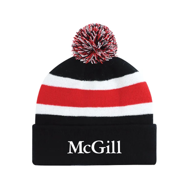 Black McGill pom‑pom tuque with white and red stripes, ribbed cuff, and embroidered McGill wordmark.