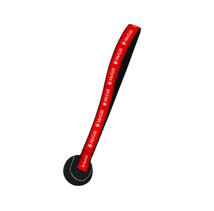 Tug toy featuring a nylon strap with red ribbon printed with the McGill logo and black tennis ball attached at the end