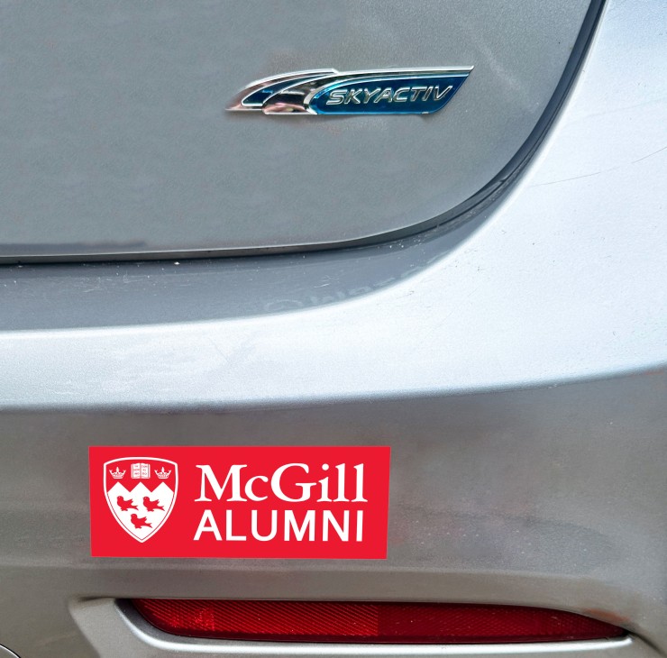 Red sticker featuring the McGill Logo and the word Alumni on a car bumper