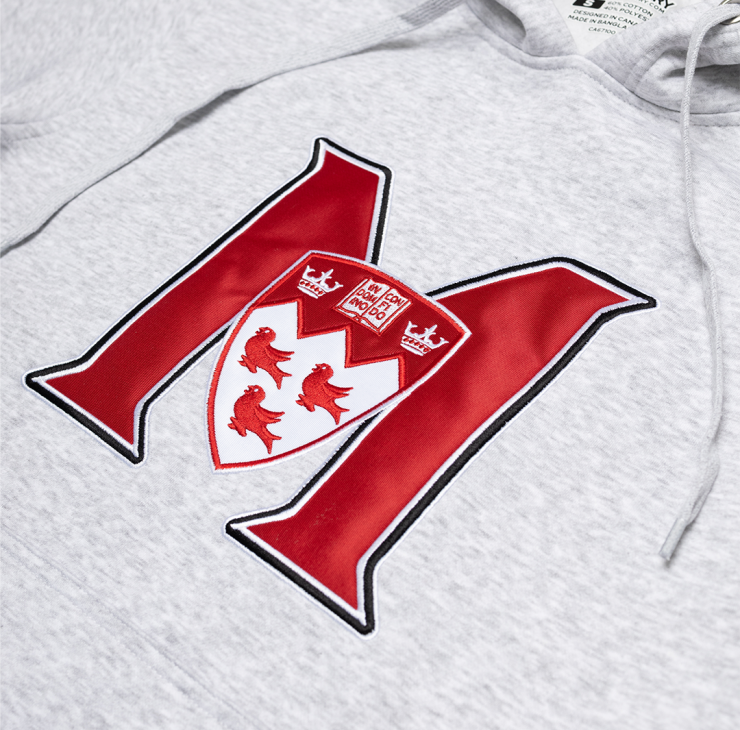 UNISEX – This classic fit pullover hoodie features a relaxed, comfortable silhouette that is neither too tight nor too loose. It offers ample room for layering without being baggy, making it ideal for everyday wear. The double fleece-lined hood is perfect for chilly weather. With ribbed cuffs and waistband, it features the McGill Athletics logo front and center so everyone knows which team you are cheering for.