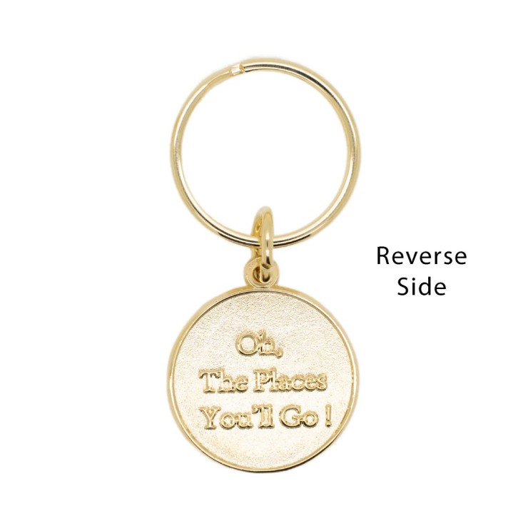 a shiny gold round medallion with the quote  "Oh, The Places You'll Go!" from Dr.Seuss embossed on the medallion
