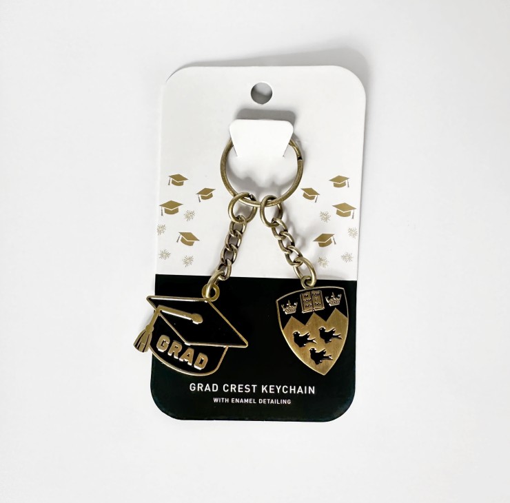 Gold finished keychain featuring a cut out grad cap and McGill crest on chain hardware
