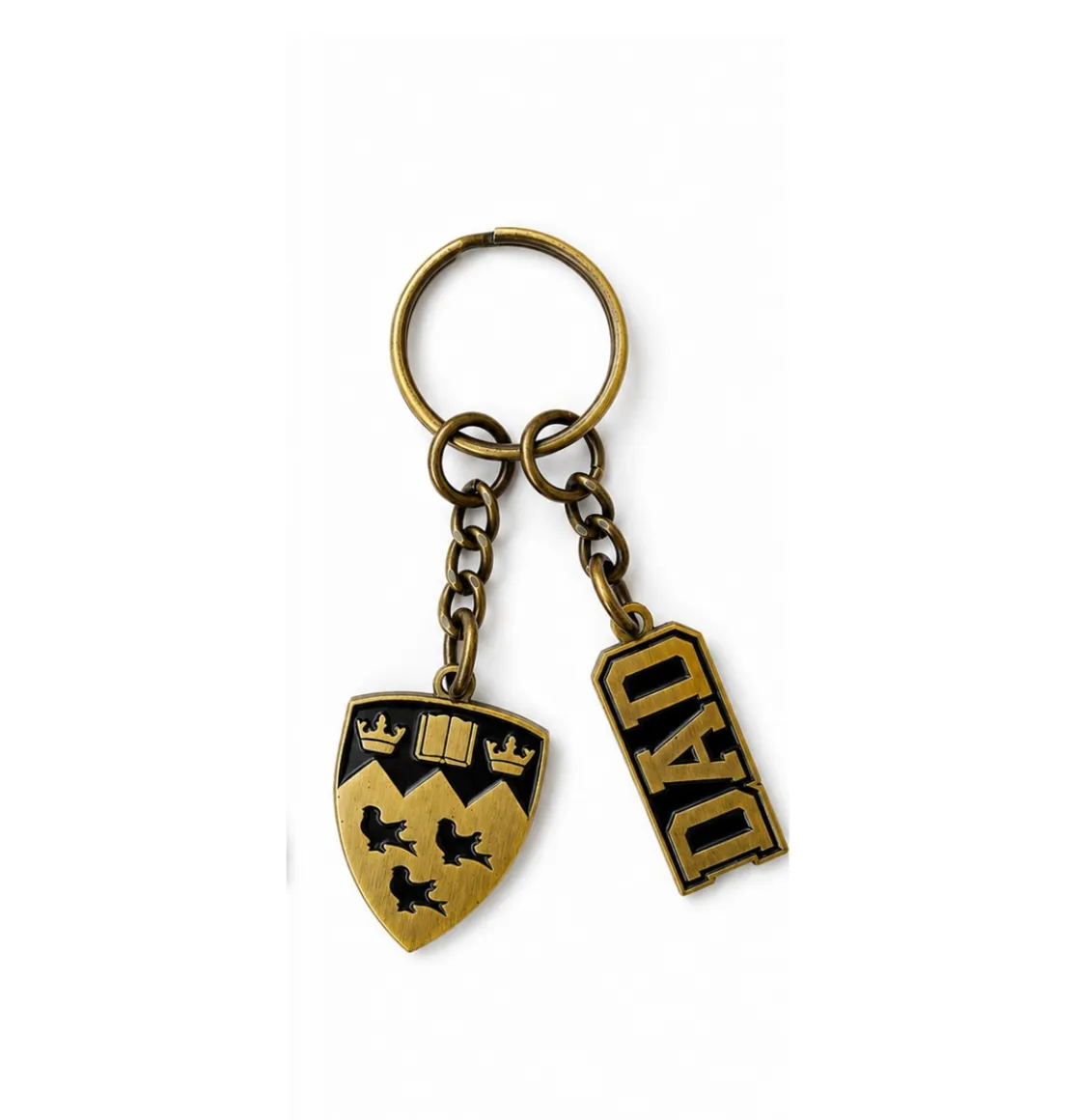 Antique gold tone McGill Dad keychain with embossed crest and “Dad” lettering on chain hardware