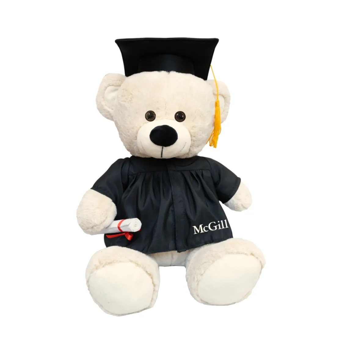 Ours en peluche beige pour la remise des diplômes de l'Université McGill, portant un chapeau noir et une toge avec un pompon doré, et tenant un diplôme roulé.