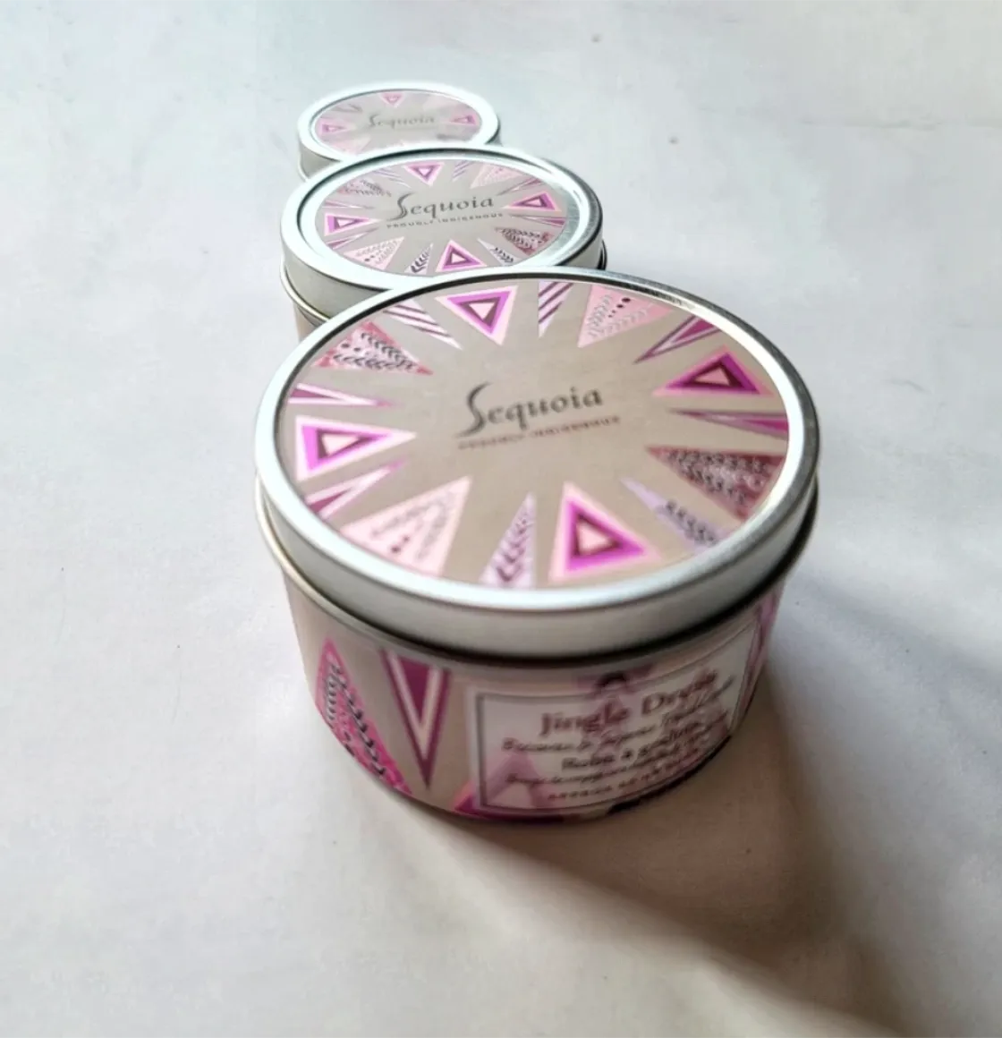 Jingle Dress fuity/floral scented candle in decorative tin with botanical pattern and silver lid.