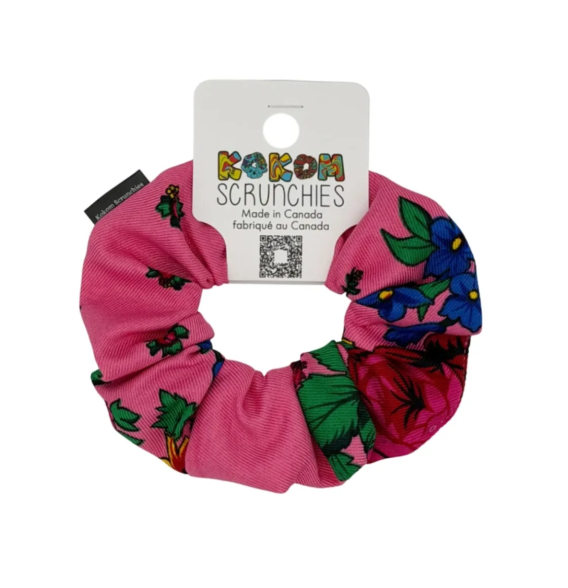 Pink floral scrunchie with vibrant red flowers and green leaves, designed by Kokom Scrunchies.