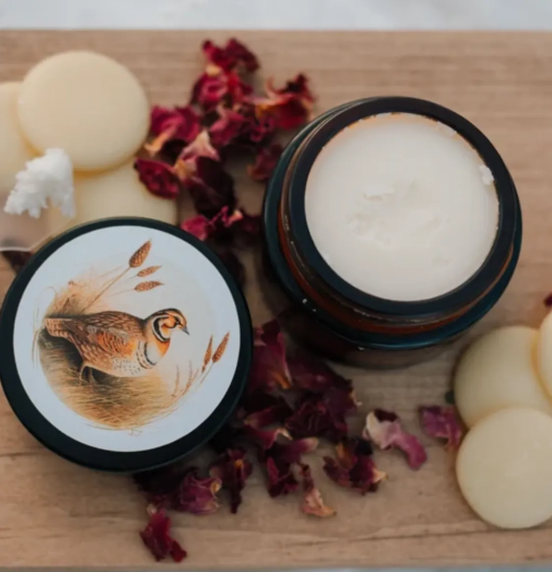 Prairie Cream moisturizer in amber glass jar with prairie bird illustration, shown open with cream balm and botanical accents.