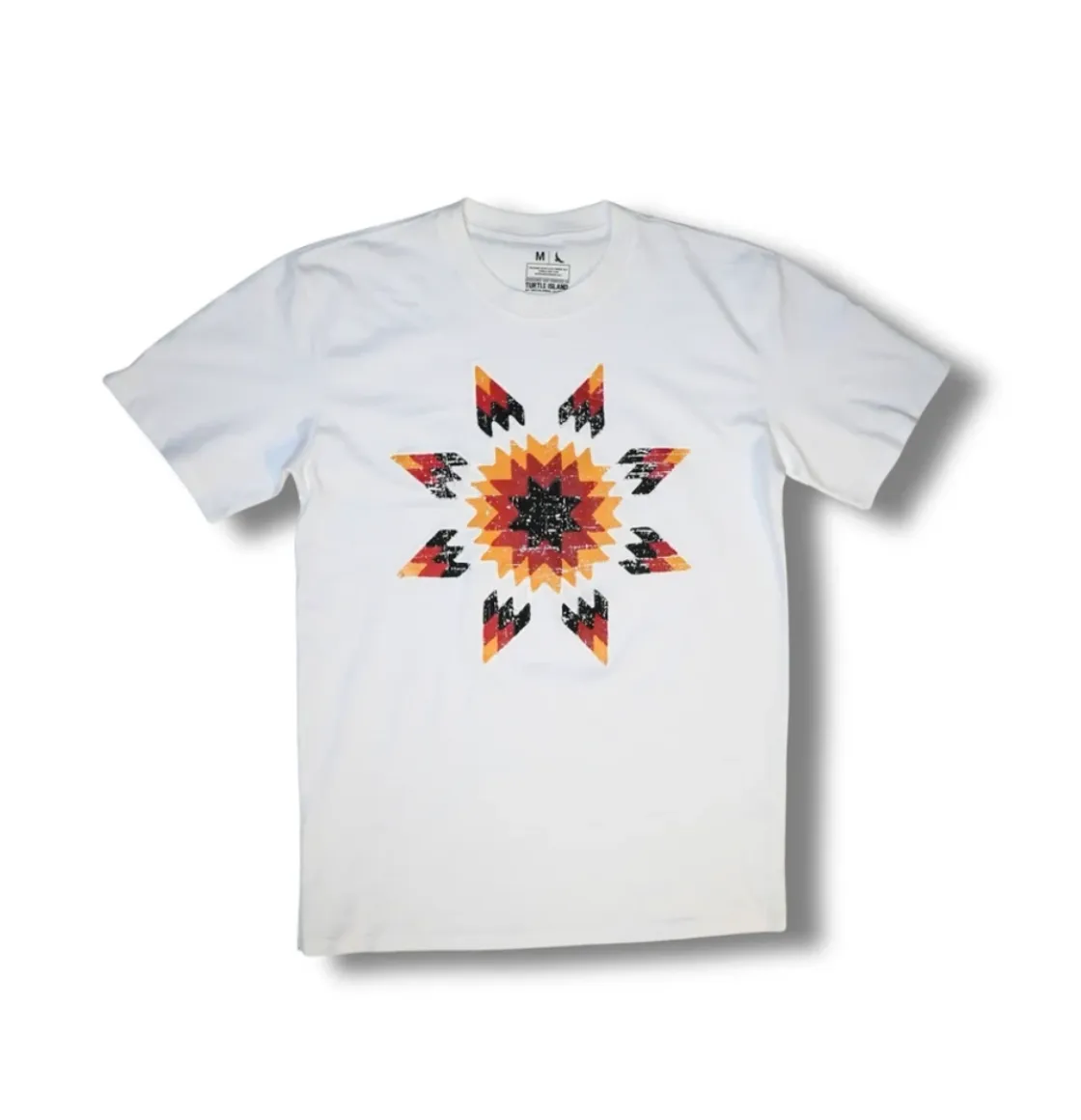 White T‑shirt featuring a multicoloured star blanket–inspired geometric design in orange, red, black, and yellow.