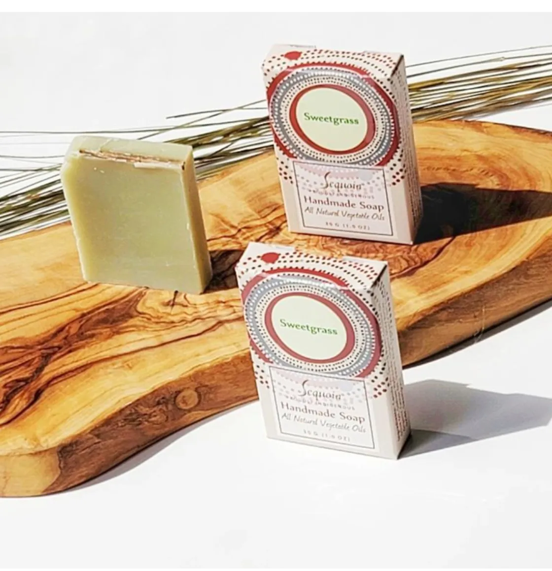 Sequoia Sweetgrass handmade soap bar with natural oils, displayed beside decorative product packaging.